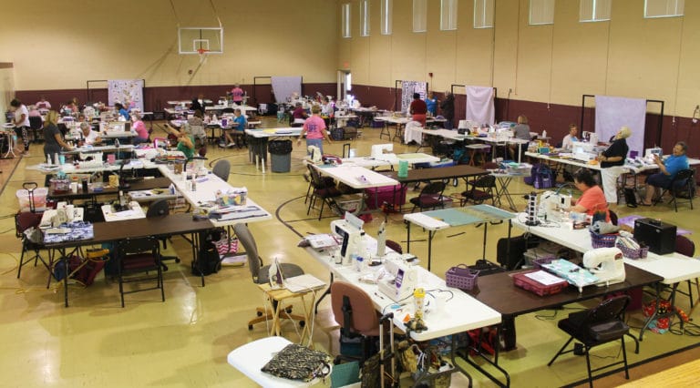 The gym is just one place quilters gather to “Sit and Sew.” There are 110 quilters this year.