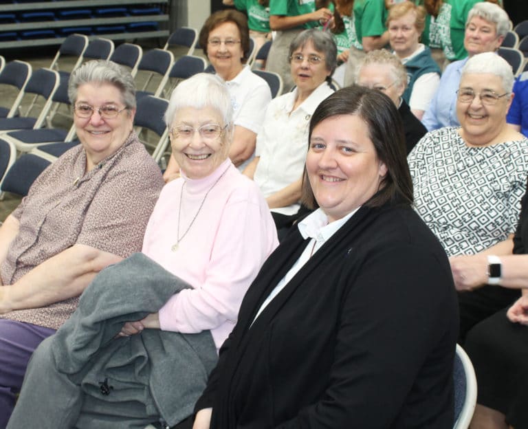Ursuline Sisters Rose Jean Powers, left, Marcella Schrant, center, and Monica Seaton share some smiles as they prepare for Mass.