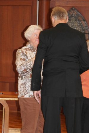 Sister Vivian Bowles places the associate pin on Ron Bornander's jacket. Sister Vivian stood in for Sister Suzanne Sims, who was on retreat.
