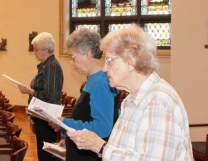 After the Ursuline Associates renewed their commitment, the Ursuline Sisters respond. Reciting the community response to the associates' commitment are, from left, Sisters Barbara Jean Head, Nancy Murphy, and Mary Sheila Higdon.