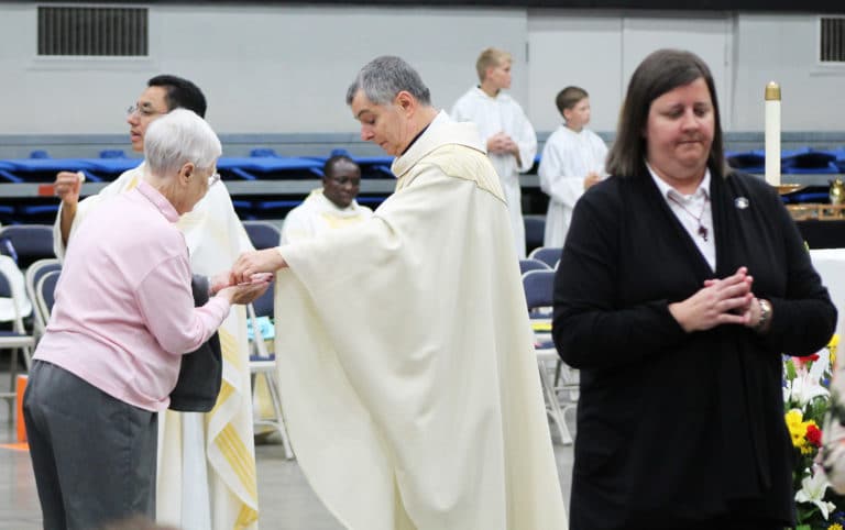 Bishop Medley gives Sister Marcella Schrant the eucharist, as Sister Monica Seaton prepares to take the wine during communion.