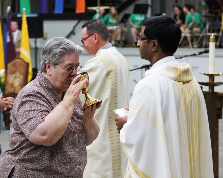 Sister Rose Jean Powers sips the wine during communion.