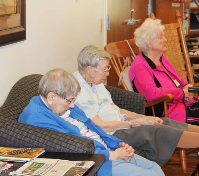 The Sisters pause during the opening prayer of the afternoon session. From left are Sisters Susanne Bauer, Amanda Rose Mahoney and Vivian Bowles.