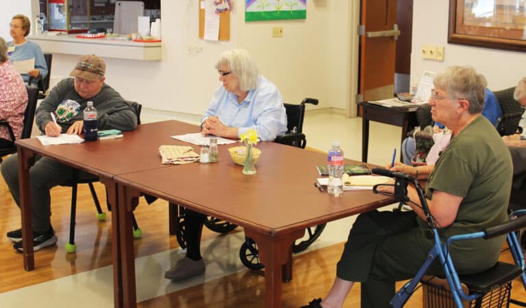 Ursuline Associate Mary Danhauer, left, takes notes, as Sister Sheila Anne Smith, center, and Sister Emma Anne Munsterman listen to Marie Dennis talk about forgiveness. “Forgiveness doesn’t mean letting terrorists do what they want. It means there is a different way to respond than with violence,” she said.