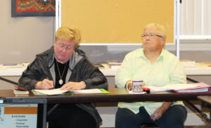 Sister Margaret Link, left, an Ursuline Sister of Cleveland, takes notes as Linda Yarwood listens to Sister Cheryl.
