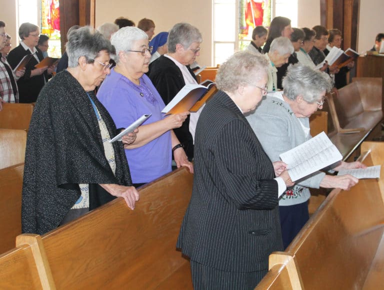 Joining the singing of the opening hymn “Here I Am Lord” are, from left, Ursuline Sisters Luisa Bickett, Ann McGrew, Emma Anne Munsterman, Marie Joseph Coomes and Teresa Riley.