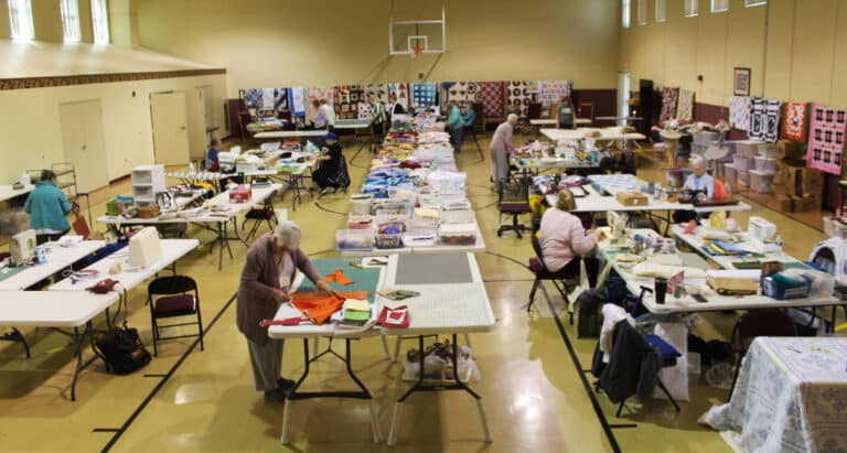 Maple Hall is full of tables and sewing machines for the Quilting Friends on the morning of March 11. More quilters arrived later in the day.