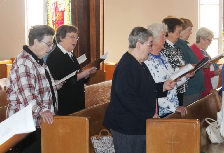 Joining in the singing, from left, are Ursuline Sisters Sharon Sullivan, Amelia Stenger, Rose Jean Powers, Vivian Bowles, Susan Mary Mudd, Helena Fischer and Pam Mueller.