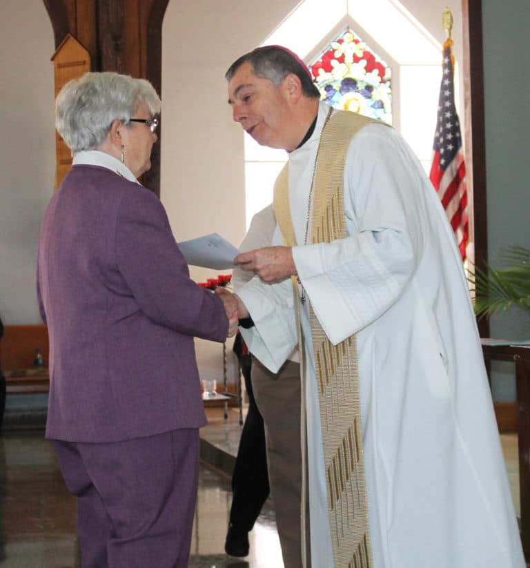 Each of the jubilarians present received congratulations and a certificate from Bishop Medley. Here, Sister Cecelia Joseph Olinger, celebrating 60 years, is congratulated by the bishop.