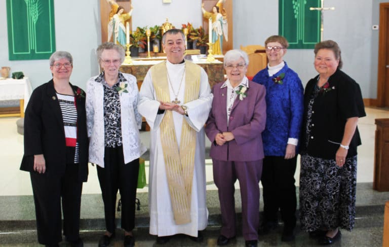 The jubilarians present join with Bishop Medley after the service. From left are Sisters Mary McDermott, Clara Reid, Cecelia Joseph Olinger, Rebecca White and Alicia Coomes.