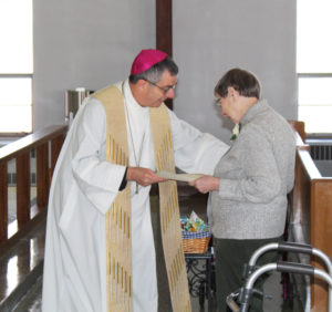 Although the Ursuline Sisters do not celebrate 65 years, the Council of Religious does. Here Ursuline Sister Susanne Bauer, celebrating 65 years, is greeted by Bishop Medley.