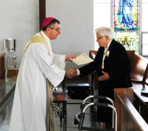 Ursuline Sister George Mary Hagan, celebrating 60 years, shakes hands with the bishop.