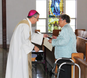 Ursuline Sister Ruth Mattingly receives her gift from Bishop Medley. She is celebrating 60 years.