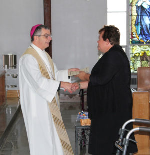 Ursuline Sister Martha Keller, celebrating 40 years, is congratulated by Bishop Medley.