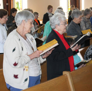 Two natives of Glennonville, Mo., Ursuline Sisters Mary Celine Weidenbenner, left, and Cecelia Joseph Olinger, sing the closing hymn.