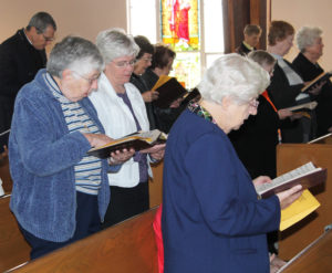 Ursuline Sisters Ruth Gehres, left, Nancy Liddy, center, and Eva Boone close out the service.
