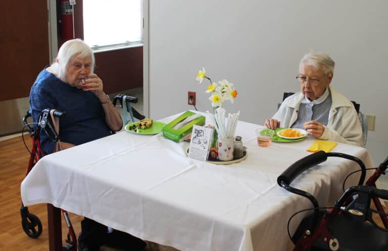 Sister Catherine Kaufman, left, enjoys some treats from Saint Joseph’s Table with Sister Marie Bosco Wathen.