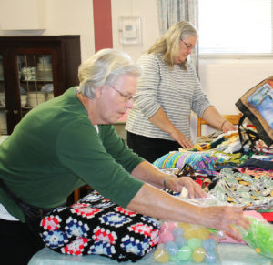 Barbara Fischer, left, and Julie Lewis, both of St. Martin Parish in Owensboro, help display items on Oct. 25 in the small dining room. Members of St. Martin priced the items for the Mount Crafts booth and worked that booth on picnic day. Barbara Fischer, left, and Julie Lewis, both of St. Martin Parish in Owensboro, help display items on Oct. 25 in the small dining room. Members of St. Martin priced the items for the Mount Crafts booth and worked that booth on picnic day.