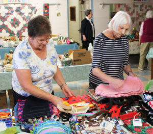 Betty Hamilton, left, and Lucy Hines, both of St. Martin Parish, get craft items ready for the sale.