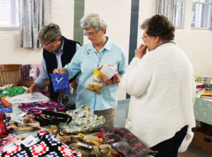 Leadership members Sister Judith Nell Riney, left, and Sister Pam Mueller do a little shopping during a break in their Council meeting, as Sister Paul Marie Greenwell joins them.