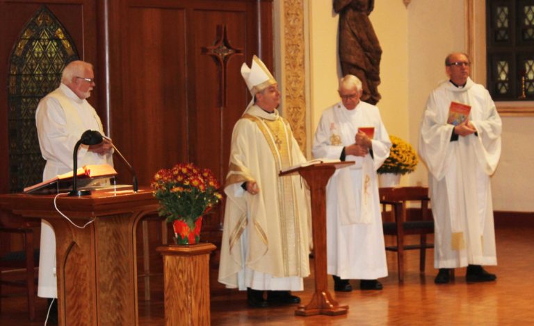 The Most Rev. William Medley, bishop of the Diocese of Owensboro, second from left, concelebrated the Mass with Father Ray Goetz, left, Father Richard Powers, second from right, and Father Harry Hagan. Father Hagan, from Saint Meinrad Archabbey, wrote the lyrics to the Father Volk hymn “Come and See the Many Wonders,” which was the closing hymn.