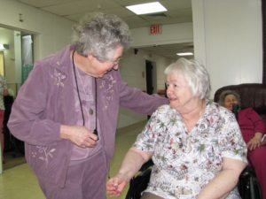 Sister Teresa Riley, left, shares a smile with Shirley Mangan at the Calvert City (Ky.) Convalescent Center on March 6. 