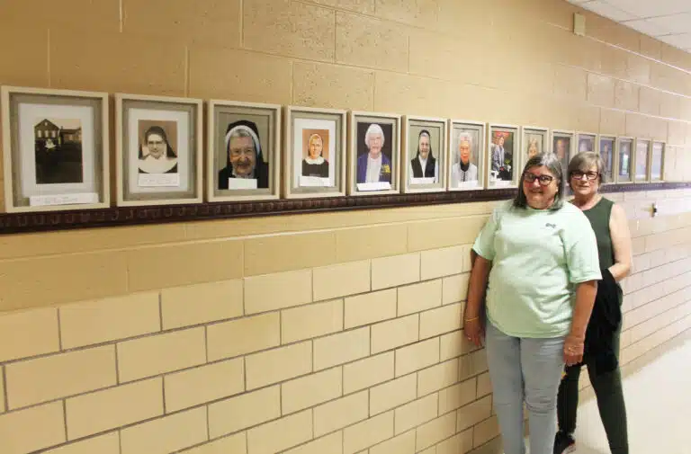 Laquita McCarty, left, and Sue Hamilton stand in the hallway of the St. Elizabeth Parish Hall where photos honor the religious sisters and priests who grew up at St. Elizabeth. The parish hall is the former St. Elizabeth School, where the Ursuline Sisters taught until 1973. Laquita McCarty, left, and Sue Hamilton stand in the hallway of the St. Elizabeth Parish Hall where photos honor the religious sisters and priests who grew up at St. Elizabeth. The parish hall is the former St. Elizabeth School, where the Ursuline Sisters taught until 1973.