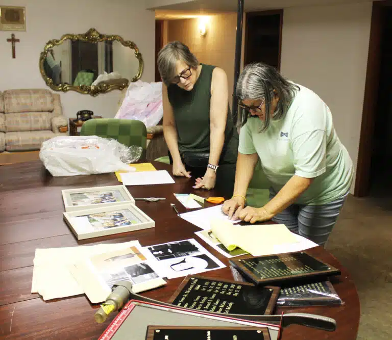 Laquita McCarty, right, and Sue Hamilton look over some information in the St. Elizabeth Parish basement on May 29, 2024, as they work to complete the photos and plaques honoring the women religious and priests from the parish. Laquita McCarty, right, and Sue Hamilton look over some information in the St. Elizabeth Parish basement on May 29, 2024, as they work to complete the photos and plaques honoring the women religious and priests from the parish.