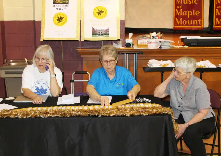 Karen Higdon, left, is assisted by Sister Betsy Moyer, center, and Sister Mary Celine Weidenbenner during registration on June 8, 2024. Higdon served in administration for the camp from 1996 until 2005. Karen Higdon, left, is assisted by Sister Betsy Moyer, center, and Sister Mary Celine Weidenbenner during registration on June 8, 2024. Higdon served in administration for the camp from 1996 until 2005.