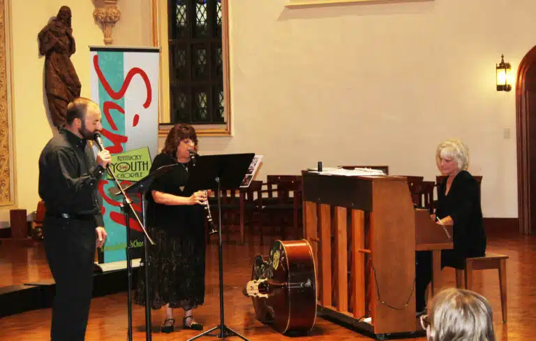 Anne Wilcheck-Schuesseler, center, plays the clarinet, as her son, Christian Burch, sings and is accompanied by Linda Bernhardt on piano. Wilcheck-Schuesseler said she is part of four generations of musicians. Burch sang “I Can Only Imagine” as he did at his grandmother’s funeral. “She was instrumental to my love of music and my faith,” he said. Anne Wilcheck-Schuesseler, center, plays the clarinet, as her son, Christian Burch, sings and is accompanied by Linda Bernhardt on piano. Wilcheck-Schuesseler said she is part of four generations of musicians. Burch sang “I Can Only Imagine” as he did at his grandmother’s funeral. “She was instrumental to my love of music and my faith,” he said.