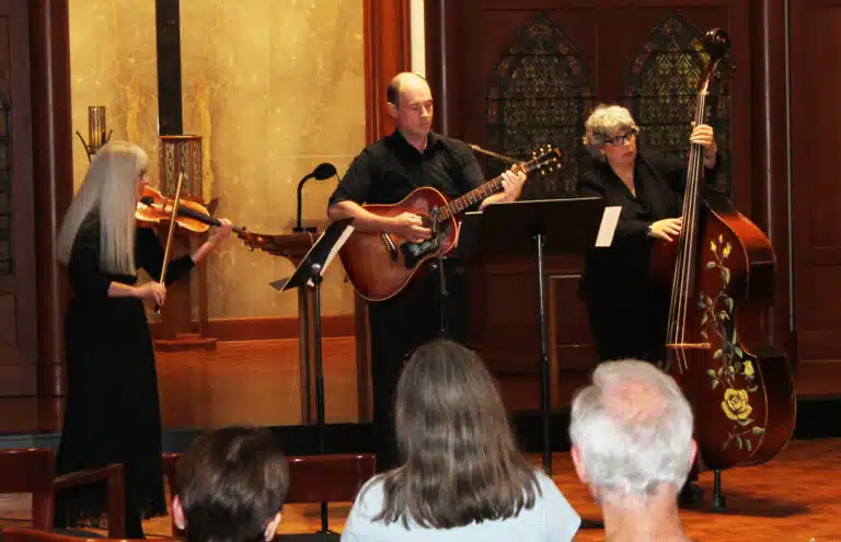 Helen Bohannon, left, a former instructor at the camp, plays “Fiddler Going Home” by Mark O’Connor, accompanied by Bryan Heath on guitar and Jamie Dixon on double bass. Helen Bohannon, left, a former instructor at the camp, plays “Fiddler Going Home” by Mark O’Connor, accompanied by Bryan Heath on guitar and Jamie Dixon on double bass.
