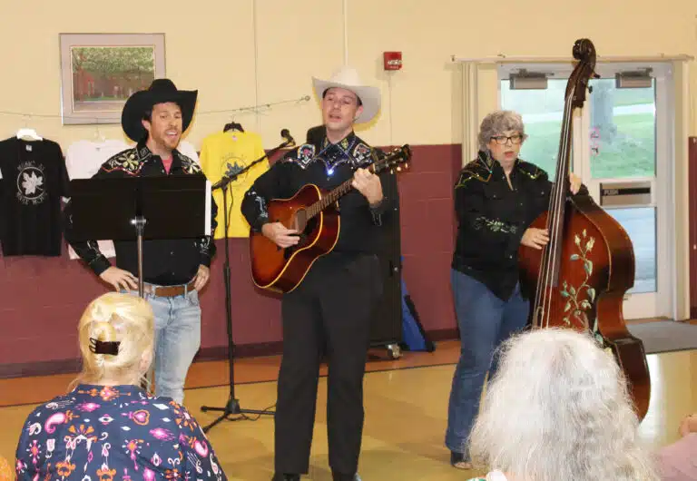 Following dinner June 8 in Maple Hall, the members of Suede Saddle – Matt Layson, left, Bryan Heath and Jamie Dixon – sing western songs to entertain their friends. The three put the group together in 2003 after meeting at the music camp. Following dinner June 8 in Maple Hall, the members of Suede Saddle – Matt Layson, left, Bryan Heath and Jamie Dixon – sing western songs to entertain their friends. The three put the group together in 2003 after meeting at the music camp.