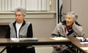 Ursuline Sisters Nancy Murphy, left, and Marietta Wethington follow along with Sister Pam’s instruction. Participants broke into three groups to discuss theological reflection later in the presentation.
