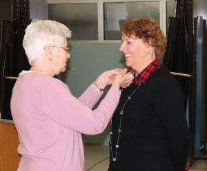 Ursuline Sister Jane Falke pins Lisa Guenther to make her final step as an Ursuline Associate.