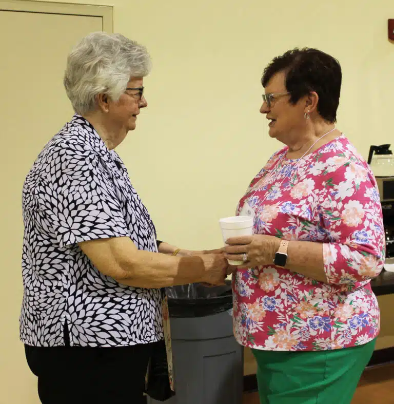 Sister Mary Timothy Bland, left, talks with Judy Bickett, a guest of Associate Phyllis Troutman from Raywick, Ky. Sister Mary Timothy Bland, left, talks with Judy Bickett, a guest of Associate Phyllis Troutman from Raywick, Ky.