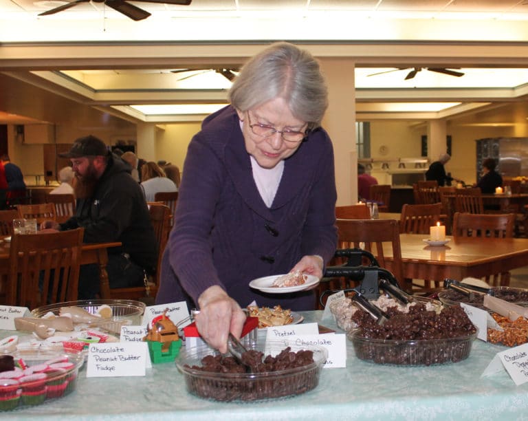 Sister Catherine Barber makes a judicious choice with the next item on her plate.