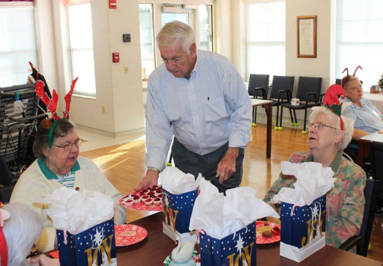 Associate Mike Sullivan offers some mini cheesecakes to Sister Paul Marie Greenwell, left, and Sister Eva Boone