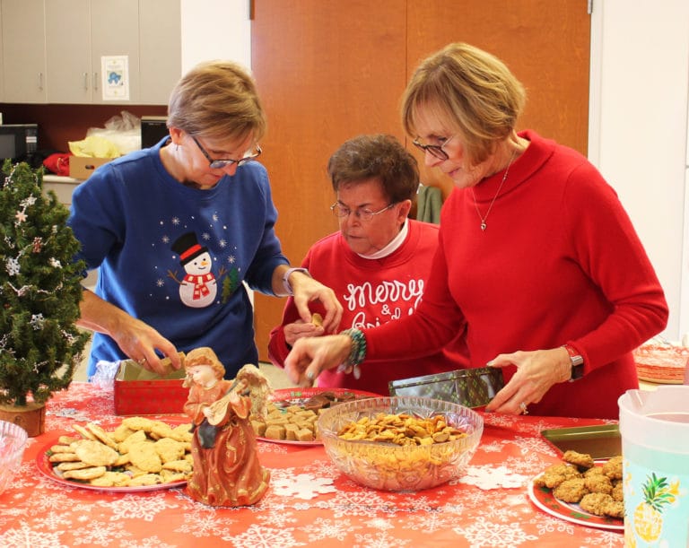 It takes a village to put on one of these parties. From left, Associates Risë Karr, Phyllis Troutman and Rosann Whiting reach a consensus on how many pieces of fudge are needed on a tray.