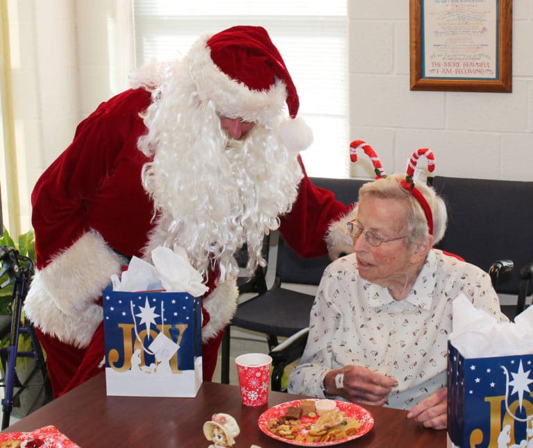 Sister Fran Wilhelm and Santa seem to be in deep conversation over the high quality of the treats.