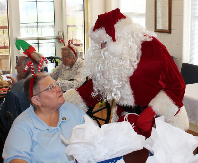 Sister Kathleen Dueber tells Santa that he did a great job with Christmas last year.