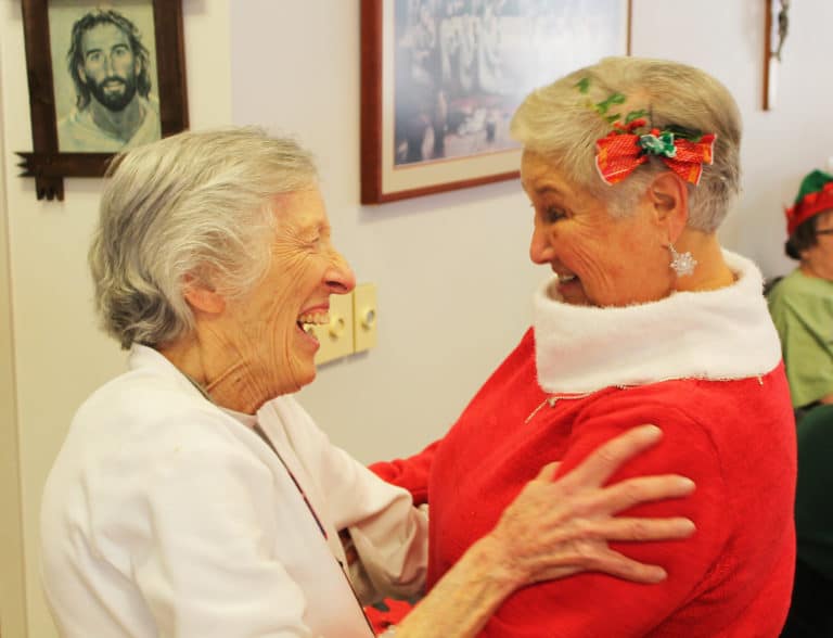Sister Marietta Wethington, left, gives Elaine Wood a hug when she arrived at the party. The two worked closely together when Sister Marietta served in Ursuline Partnerships.
