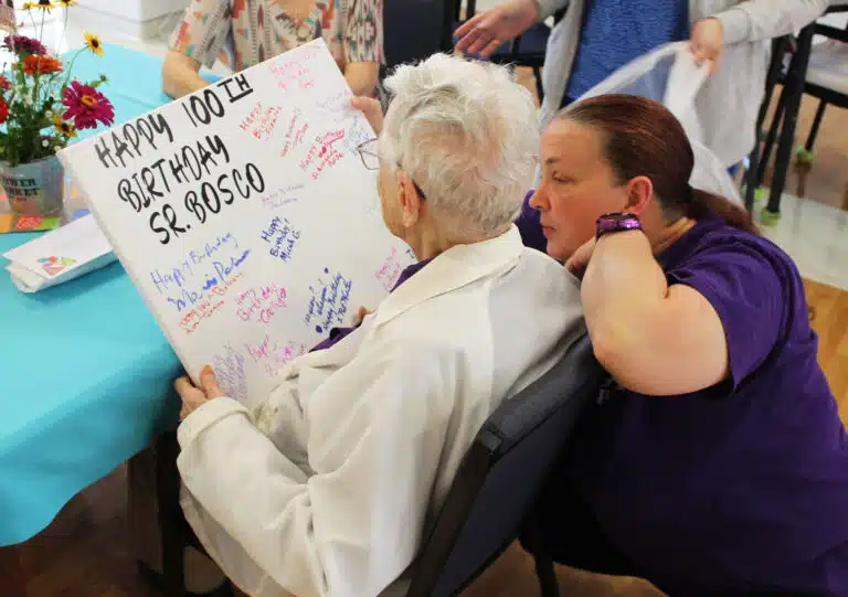 Pat Burden, a Villa worker with Almost Family, shows Sister Marie Bosco a birthday card signed by some of the staff. Pat Burden, a Villa worker with Almost Family, shows Sister Marie Bosco a birthday card signed by some of the staff.