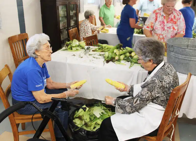 Sister Elaine Burke, left, and Sister Margaret Ann Aull discuss the finer points of corn shucking. Sister Elaine Burke, left, and Sister Margaret Ann Aull discuss the finer points of corn shucking.