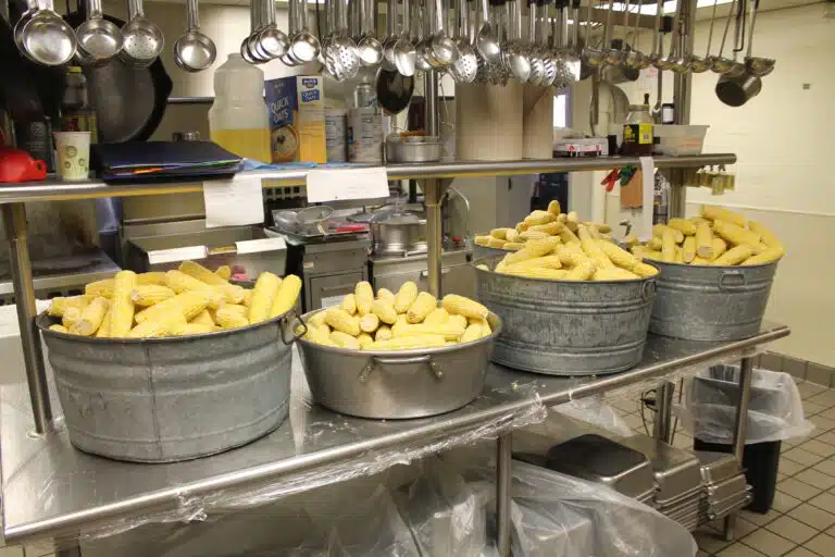 Some of the 1,500 ears of corn ready for cooking in the kitchen. Some of the 1,500 ears of corn ready for cooking in the kitchen.