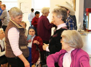Sister Mary Celine Weidenbenner, left, visits with Sister Nancy Murphy, center, and Sister Catherine Barber during a break in the action.