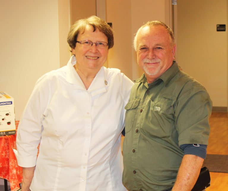 Sister Amelia congratulates Mark Blandford, farm manager, for 45 years of working for the Ursuline Sisters.
