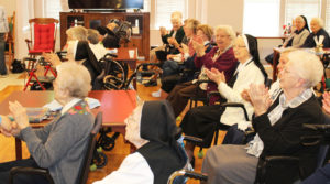 The sisters who filled the Rainbow Room applaud at the conclusion of the square dancing.