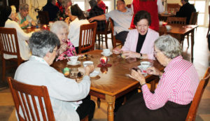 Sister Mary Henning, second from right, shares a story with Sister Grace Swift, right, as Sister Luisa Bickett and Sister Catherine Kaufman listen.