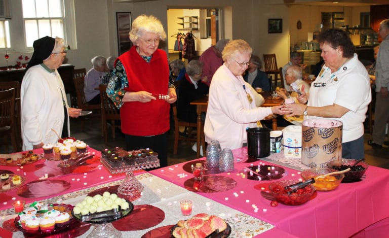 A line forms for ice cream as Sister Alicia Coomes, right, does the dipping. The sisters in line are, from left, Sisters Michael Ann Monaghan, Francis Louise Johnson and Marie Joseph Coomes.