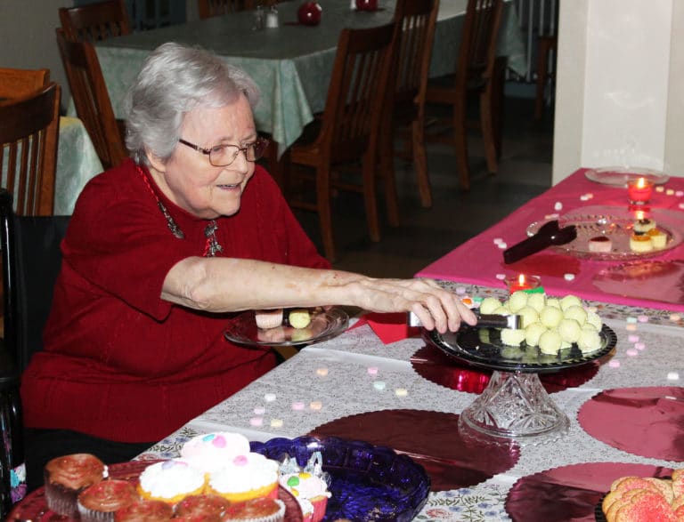Sister Pat Rhoten finally gets a chance to try some of the sweets on display.